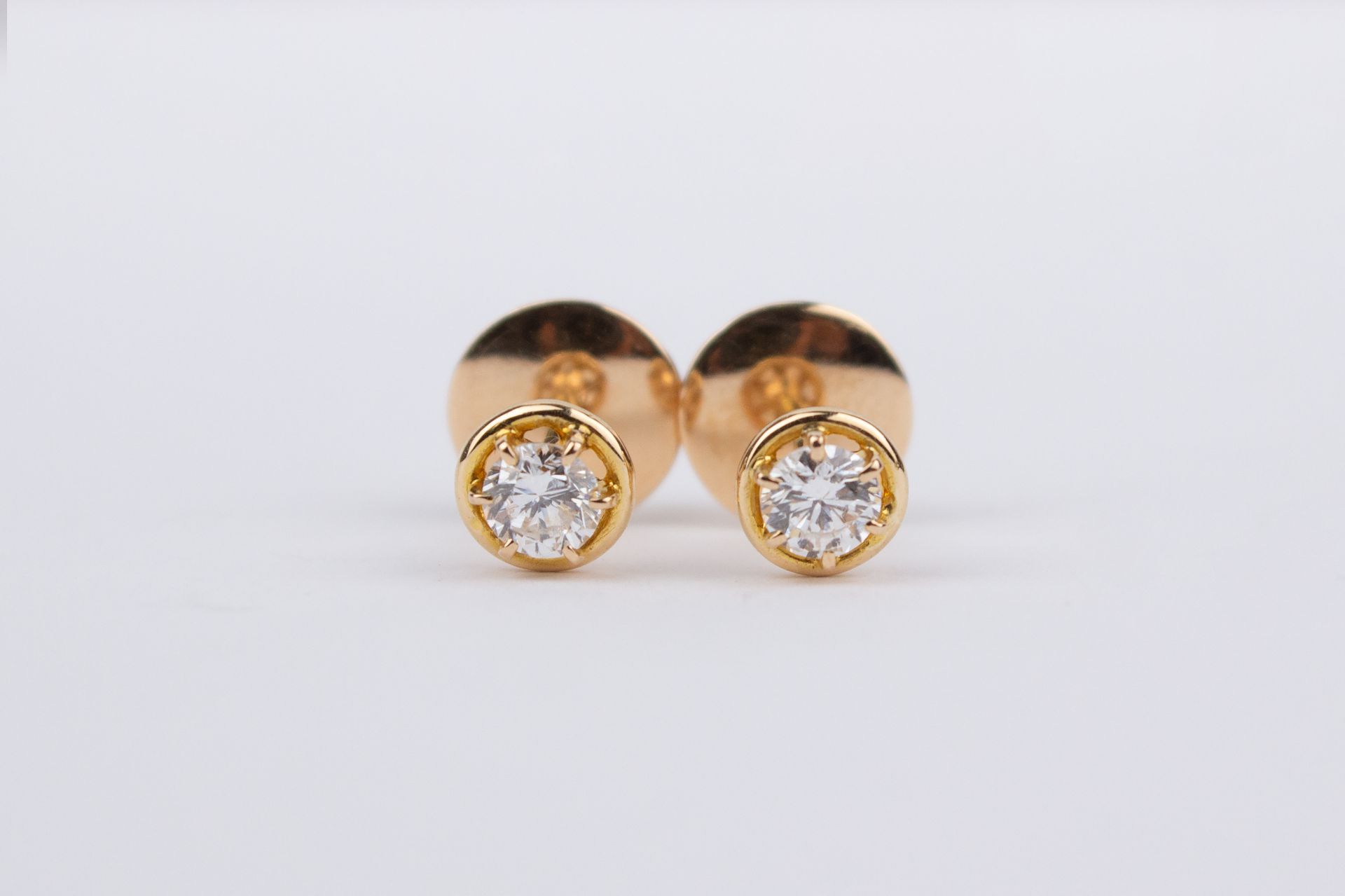 A pair of 18k. yellow gold and diamond stud earrings