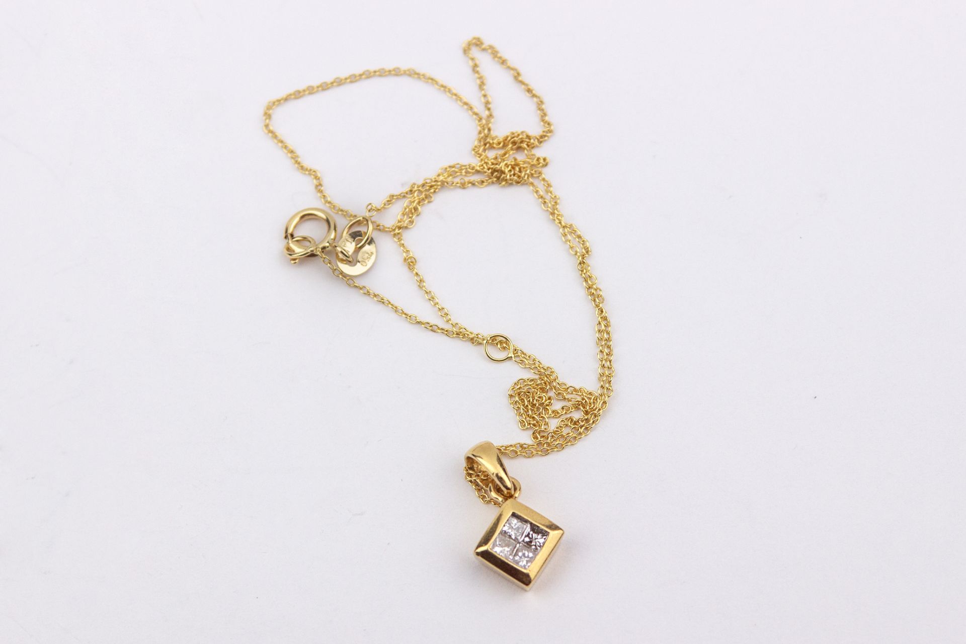 A princess cut diamonds nd 18k. yellow gold cluster pendant and chain