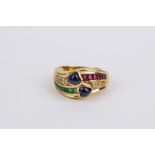 An 18k. yellow gold, sapphires, emeralds, rubies and diamonds ring