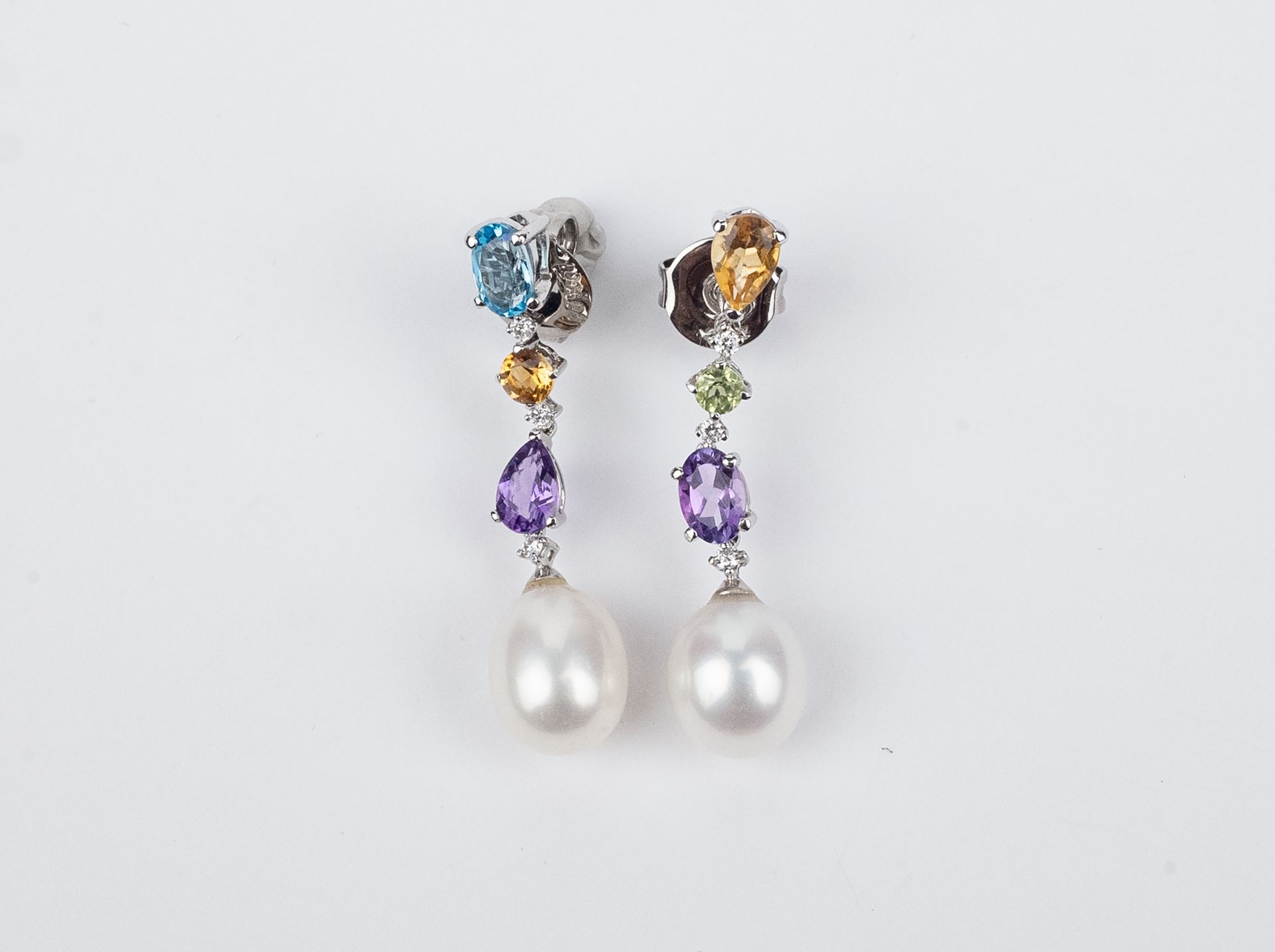 A pair of long earrings. 18k., white gold, topaz from Brazil, diamonds and cultured pearls