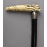 A 19th century possibly English walking stick with a carved ivory handle and a fruitwood shaft