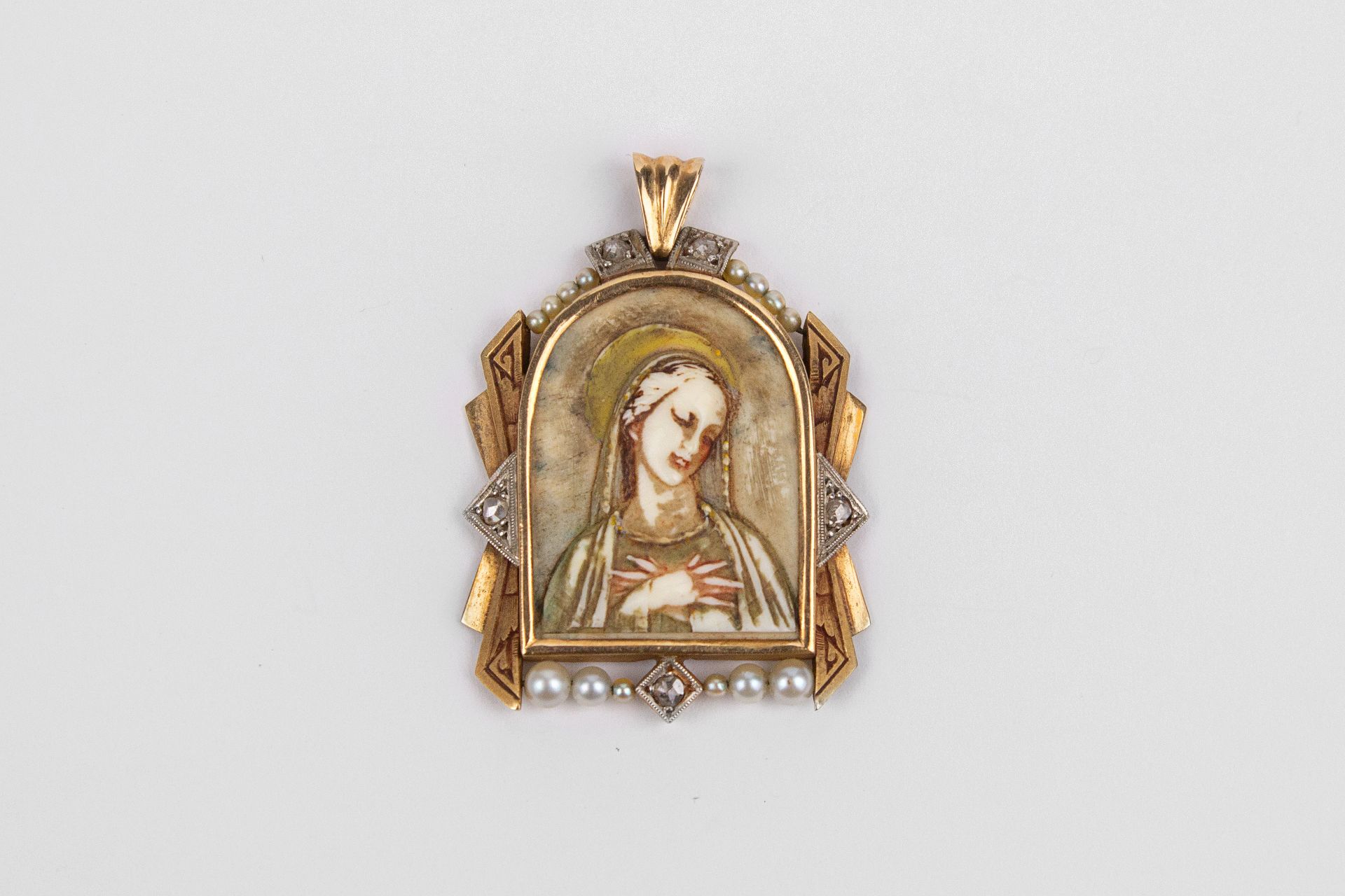 An Art-Déco gold, platinum, diamonds and pearls devotional medal circa 1940