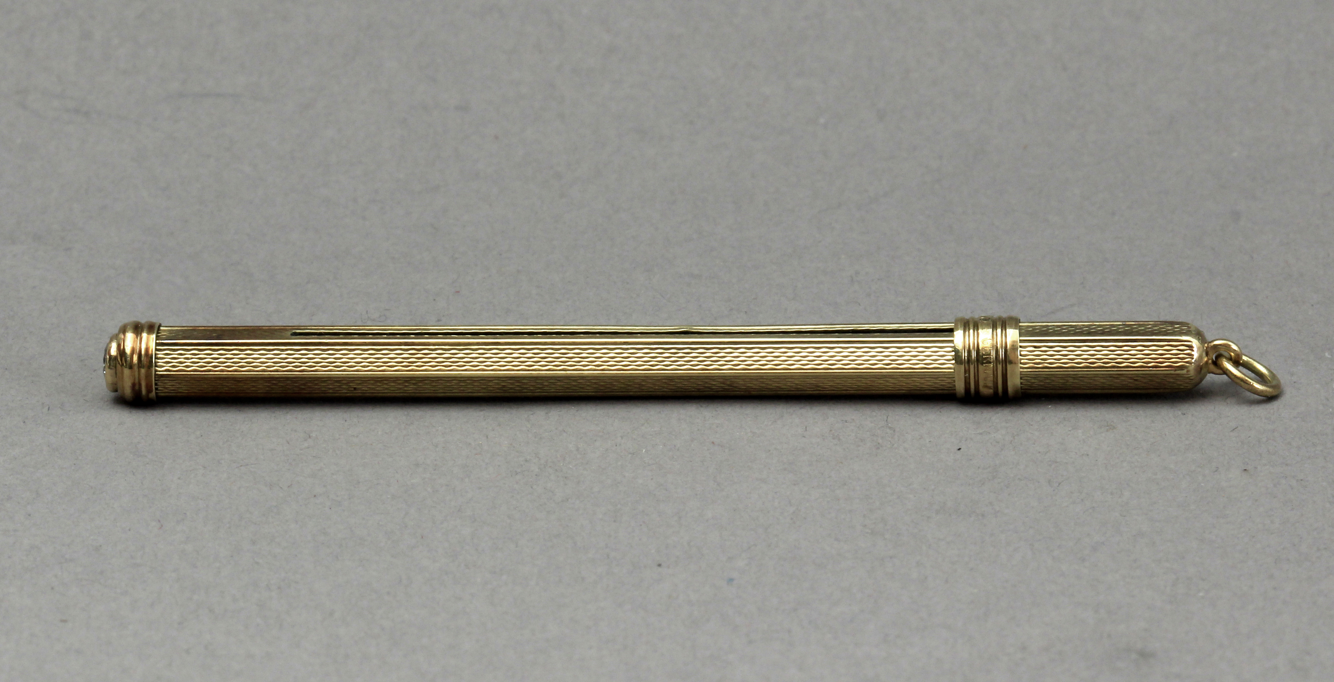 A mid 20th century 14k. gold and diamond cocktail mixer tool