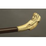 A 19th century walking stick wth a walrus ivory handle and a wooden shaft
