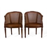 A pair of French Louis XVI style armchairs