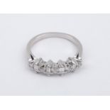 A baguette and brilliant cut diamonds half eternity ring