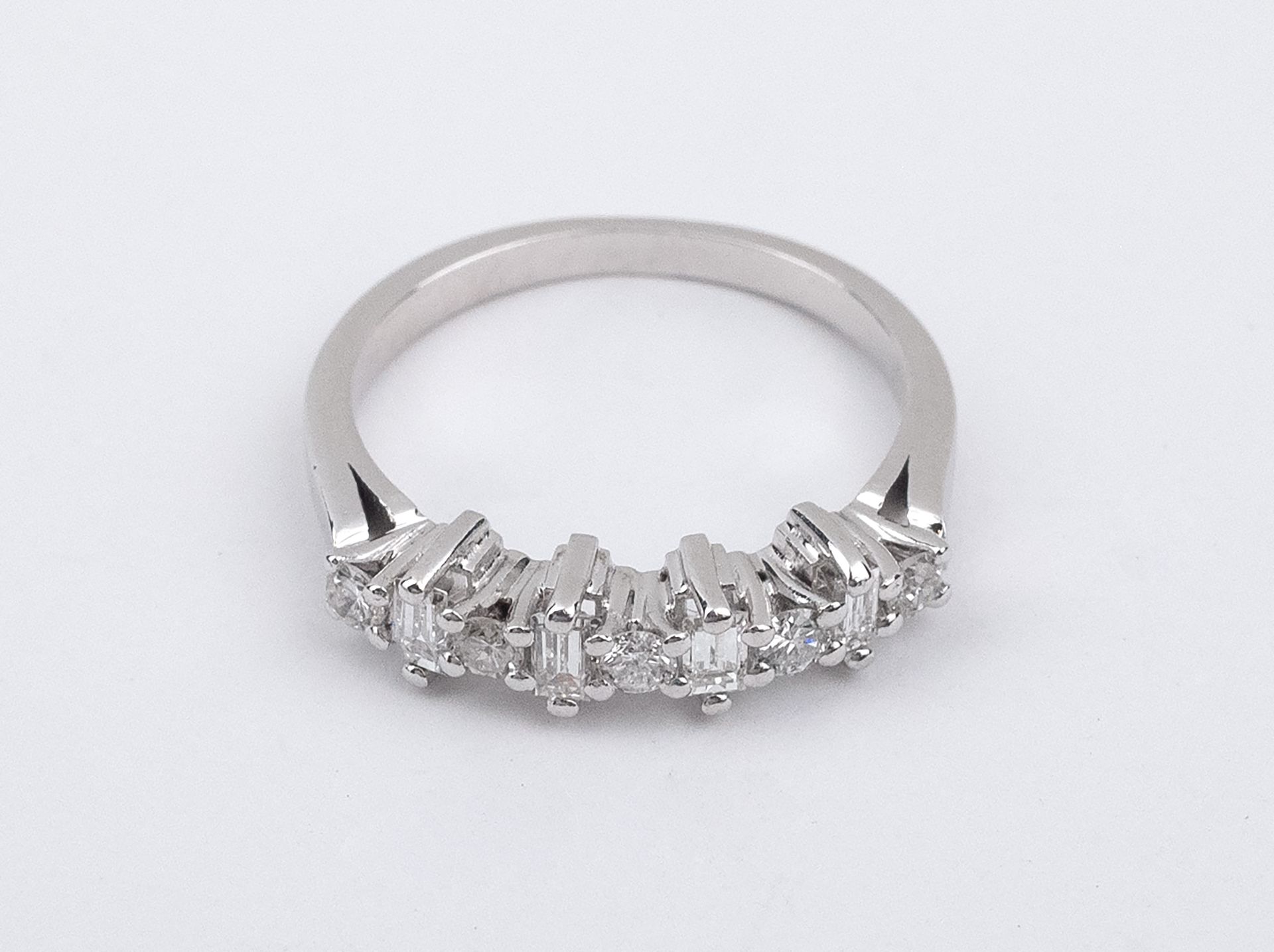 A baguette and brilliant cut diamonds half eternity ring