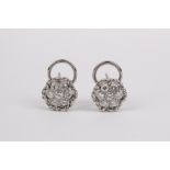 A pair of brilliant cut diamonds and 18k. white gold cluster earrings