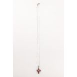 An 18k. white gold and rubies pendant cross and chain