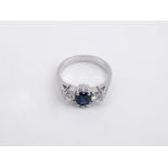 A sapphire and diamonds three stone ring