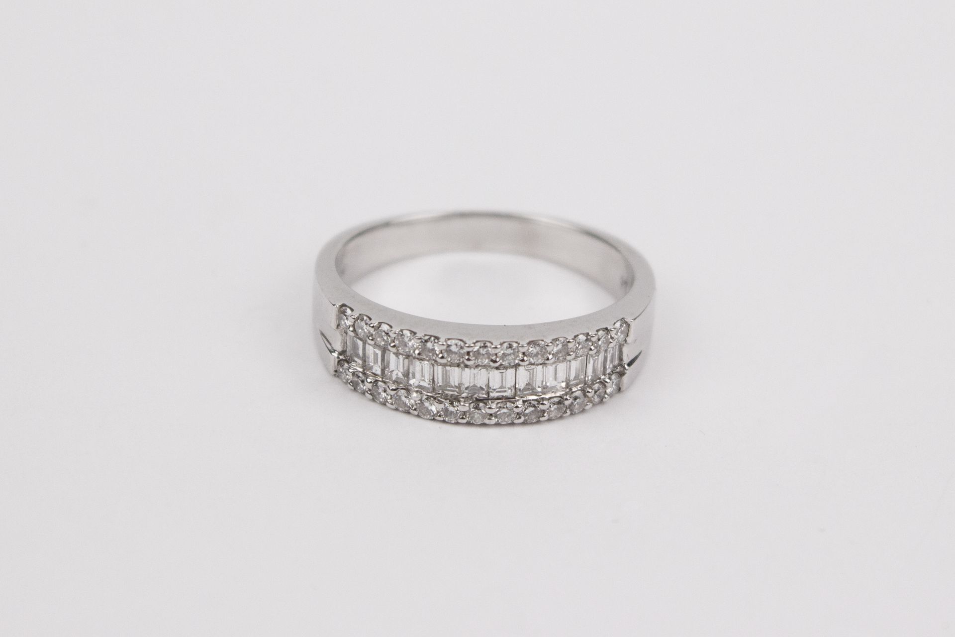 An 18k. white gold and diamonds half eternity ring