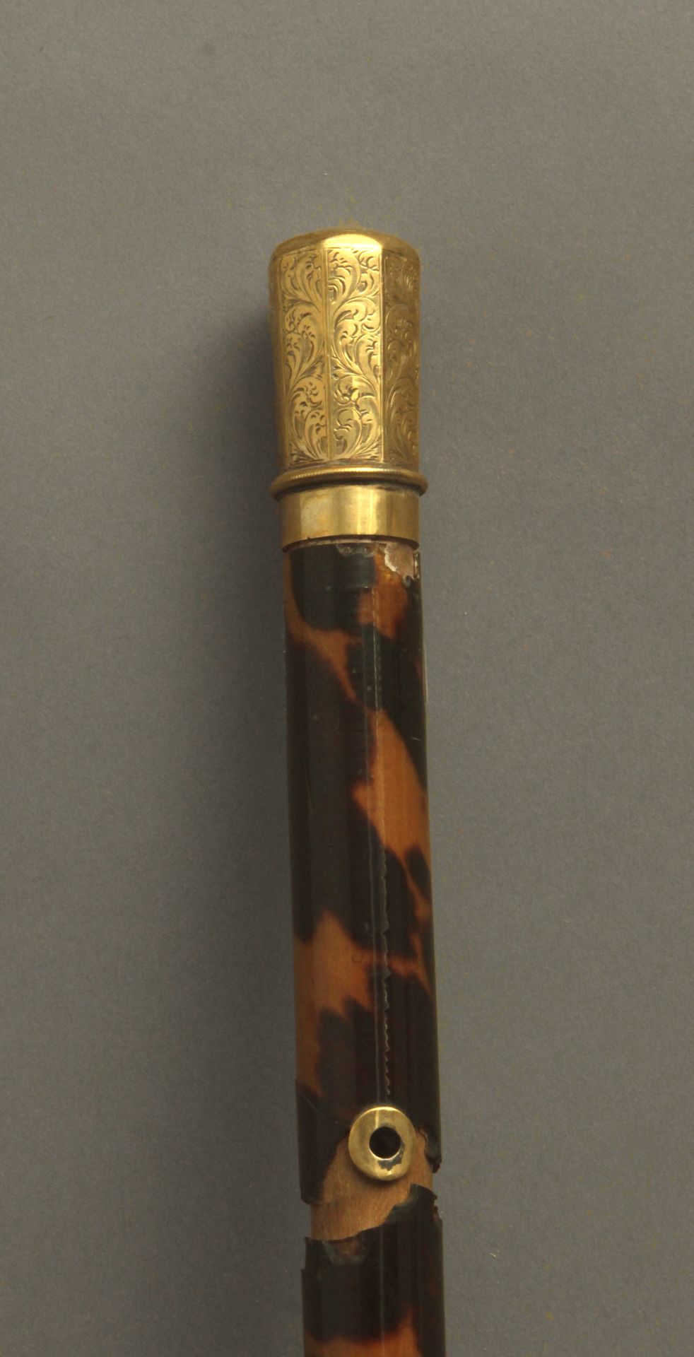 A first third of 20th century baton with a 14k. yellow gold handle and a tortoiseshell shaft
