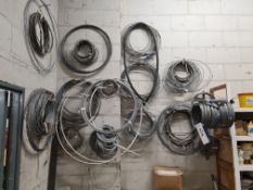 Assorted Reels of Steel Cables, as set out on wall