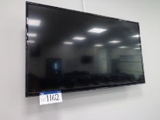 Unbranded 42” flat screen TV with remote control (