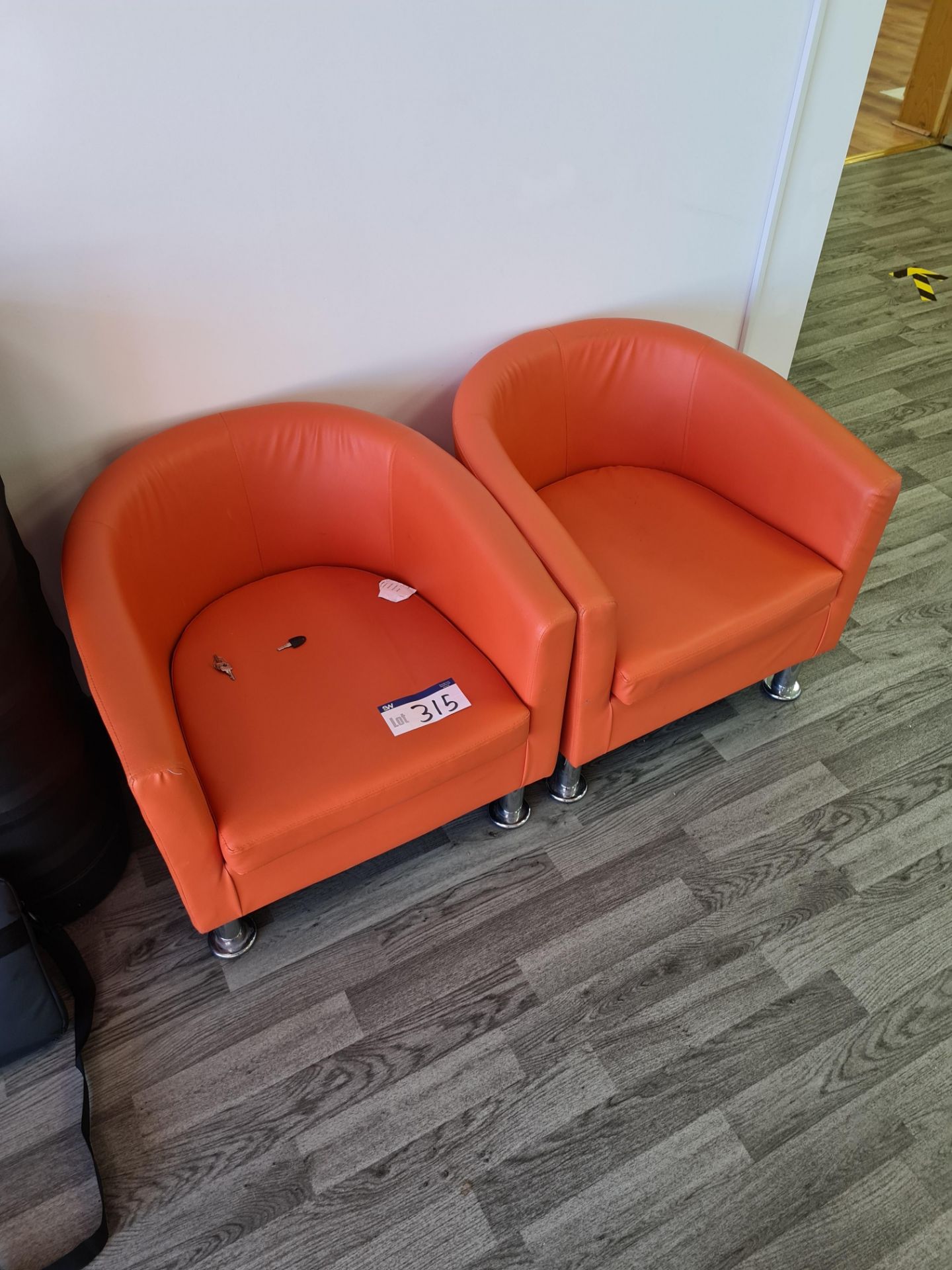Two Orange Leather Tub Armchairs (This lot is loca
