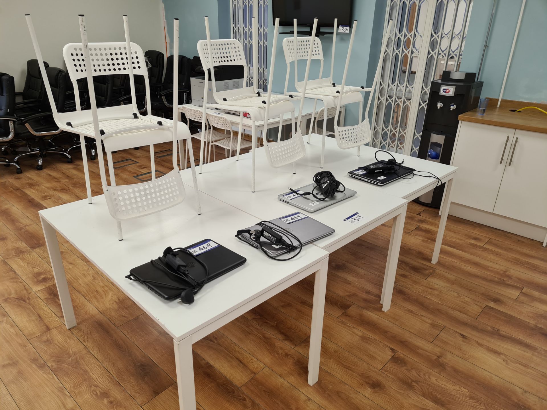 Three White Tables with Six White Plastic Chairs (