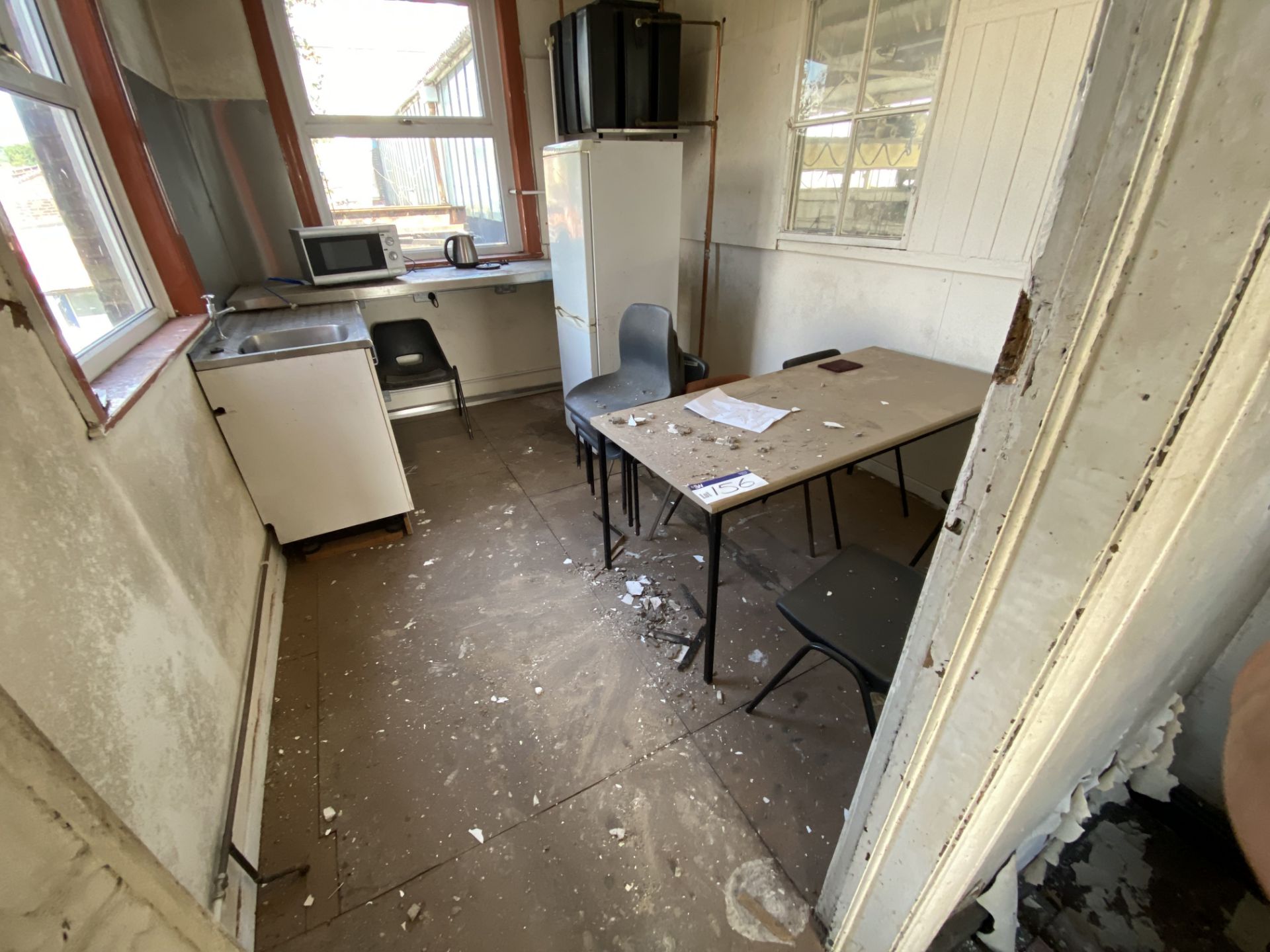 Table, with plastic stacking chairs, microwave, kettle and fridge/ freezer, in upstairs