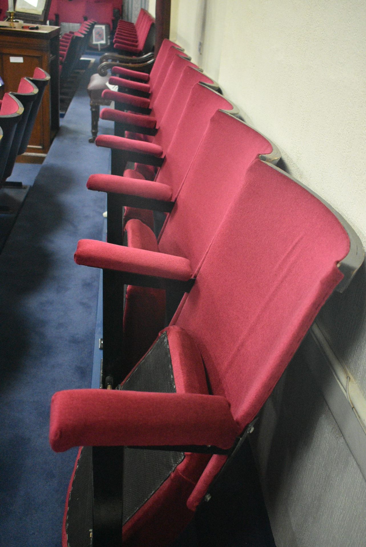 Bank of Seven Red Fabric Upholstered Fold-up Seats, 3.6m wide overallPlease read the following