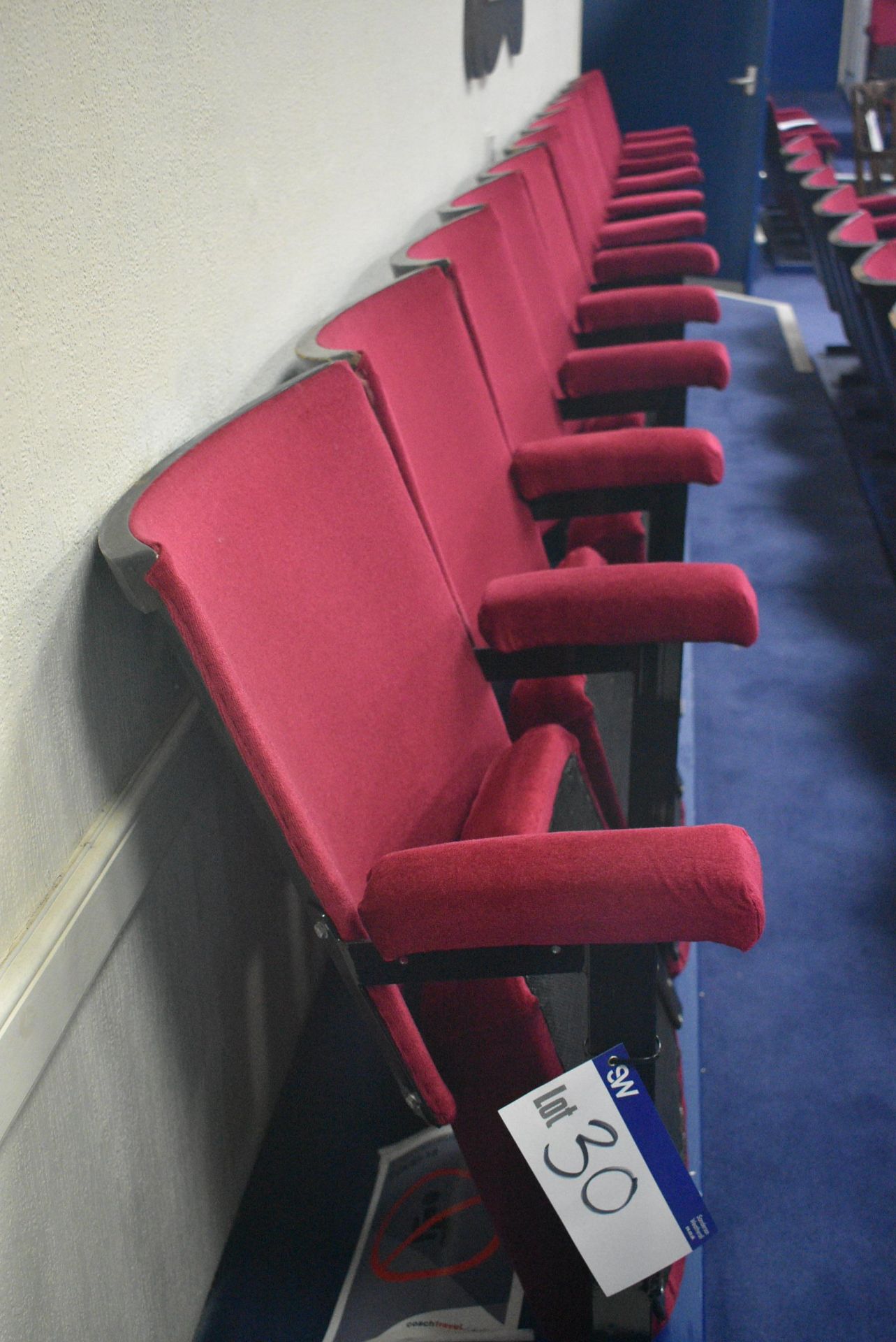 Bank of 11 Red Fabric Upholstered Fold-up Seats, 5.64m wide overallPlease read the following