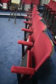 Bank of Seven Red Fabric Upholstered Fold-up Seats, 3.65m wide overallPlease read the following