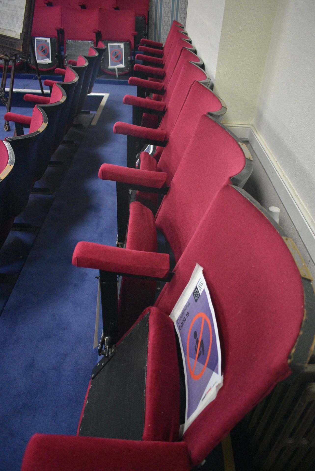 Bank of Nine Red Fabric Upholstered Fold-up Seats, 4.6m wide overallPlease read the following