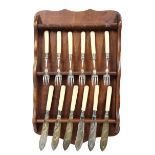 Collection of Forks & Knives on Wooden Rack