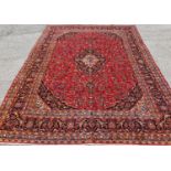 A rich red ground Persian Kashan Carpet with traditional Kashan design.