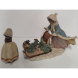 A Lladro winter Figure of dogs in a sleigh, along with another.