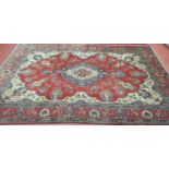 A vintage red ground Persian Tabriz Carpet with bespoke medallion design. 450 x 290 cm