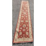 A carpet Runner with cream ground. approx 550cm long x 92cm wide.