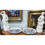 Two Parian Figures of a man and a woman(H 34cms) along with two wall Plates.D 27 cms.