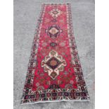 A large Iranian Runner with blue ground and cross design. 113 x 390 Cm.