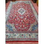 A very large red ground Persian Sarouk Carpet with red and blue ground and unique design. 536 x