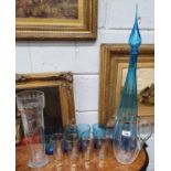 A blue and white Urn and Glasses along with a set of lemonade Glasses and a long slender Vase.