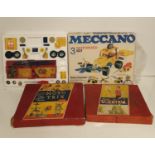 Two boxed Meccano Models, a boxed Moto Trix, along with a box of Scientrix.