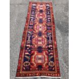 A large blue ground Iranian Runner with animal motifs and unique Bokhara design. 107 x 325 cm