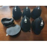 A group of 'Bobbies' Helmets and other caps.