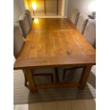 An extremely large Oak Kitchen Table with square supports and one extra leaf.