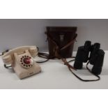 A Regent Binoculars along with a vintage bakelite telephone.