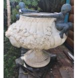 A Fabulous pair of reconstituted Stone Urns with a highly variegated outline and bronze boys jumping