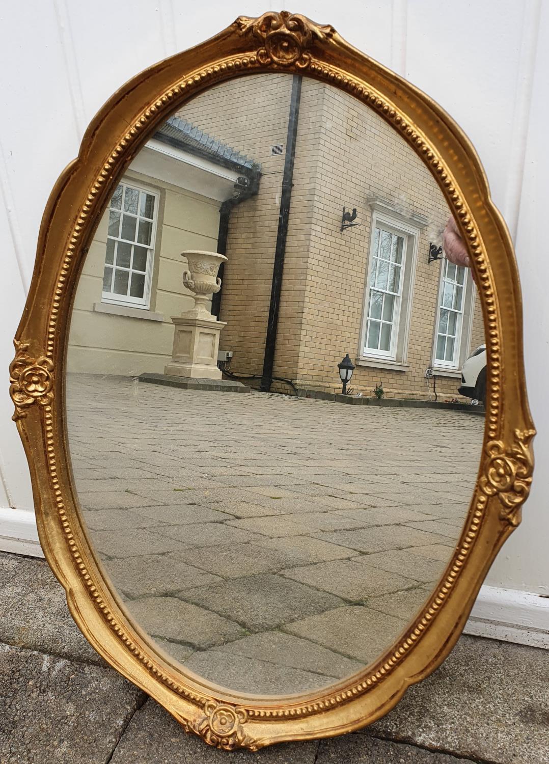 A good gilt oval mirror.