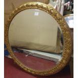 A really good circular gilt Mirror with highly carved surround. 105 cm diam.