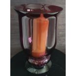 A Cranberry Glass Tealight Holder along with a Decanter.