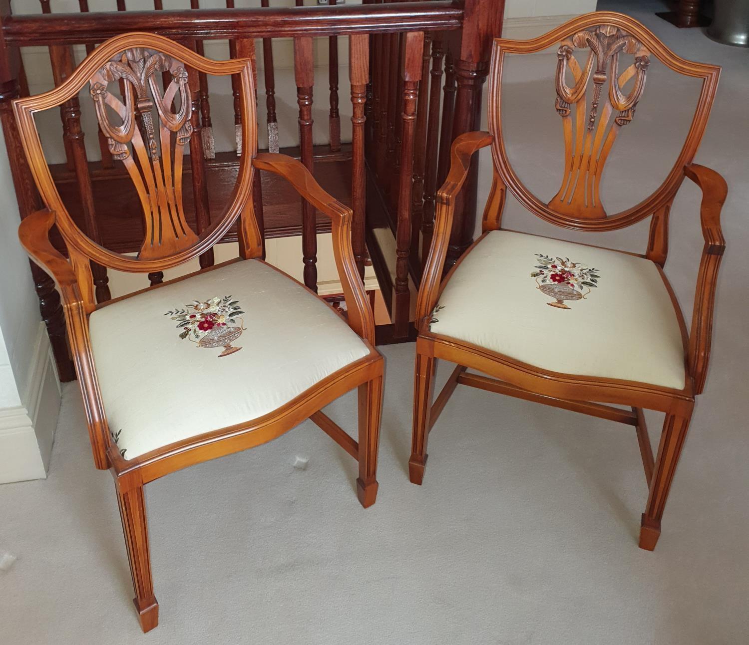 A lovely pair of Hepplewhite Carvers with Fleur de Lys backs and hand embroidered seats.