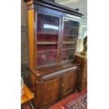 A Victorian Mahogany two door Bookcase. W 118 x D 46 x H 212 cms approx. Missing a panel of glass.