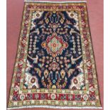 A beautiful Iranian Village Rug with with blue and red ground and floral medallion design. 206 x 130