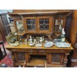 A very large early 20th Century Oak Sideboard with highly ornate paneled doors and beveled glass.W