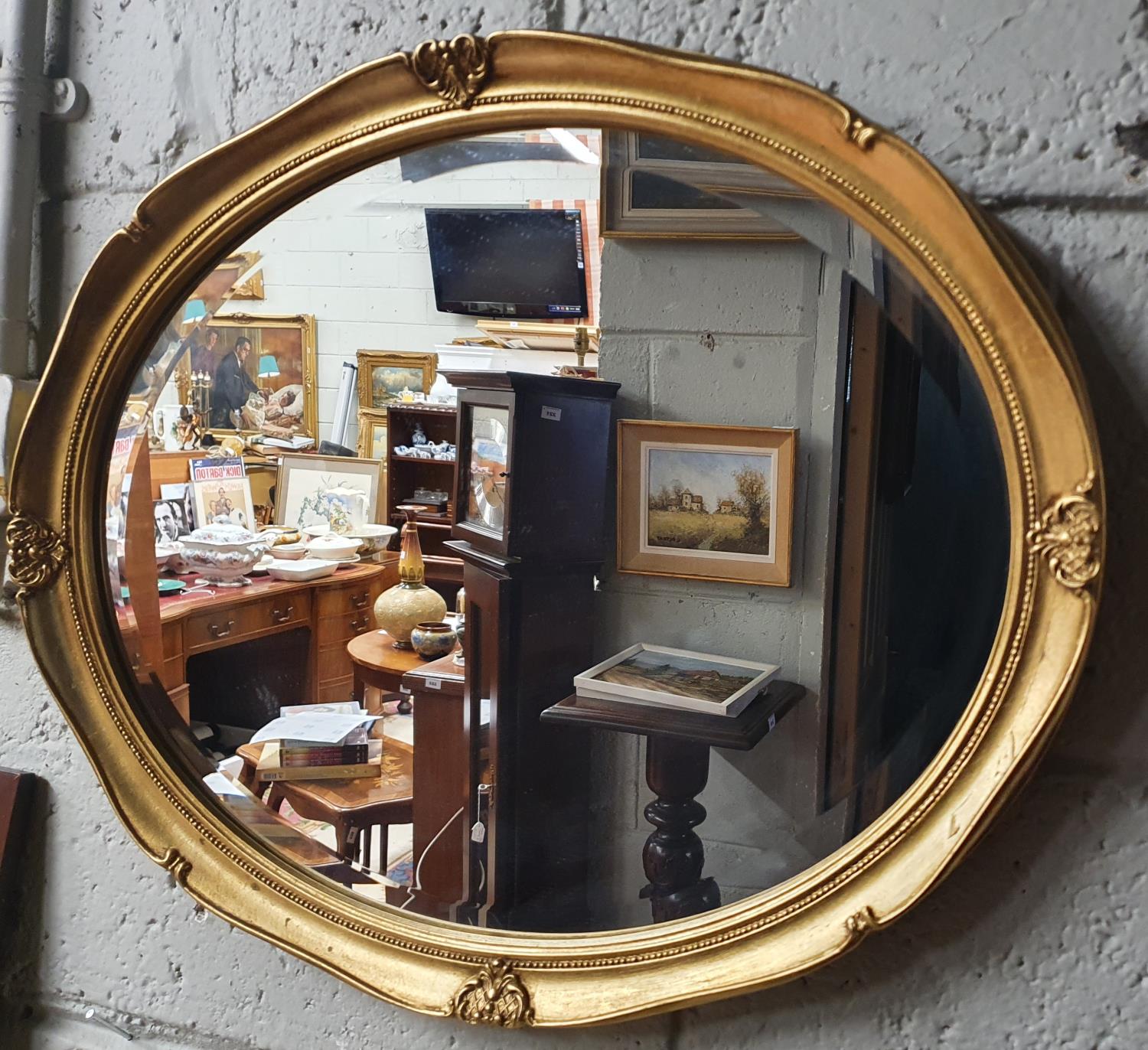 A modern Plaster Gilt Oval Mirror with bevelled glass. 56 x 46 cm approx.