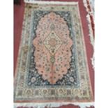 A pink ground Carpet with multi borders. 210 x 125 cms approx.