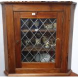 A 19th Century reclaimed stained Pine Hanging Corner Cabinet enclosed by a rectangular leaded